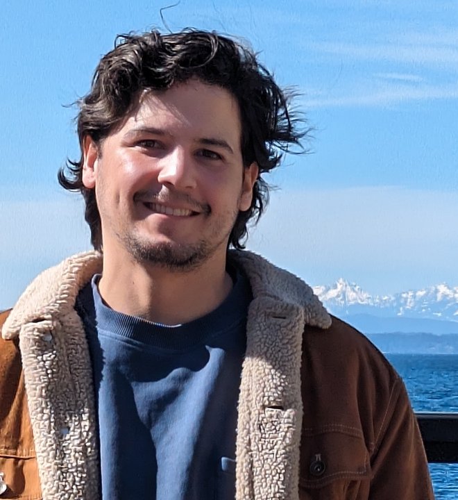 Eddie on a Seattle pier, mountains behind