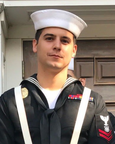 Eddie in Navy dress blues with white gloves and a ceremonial sash